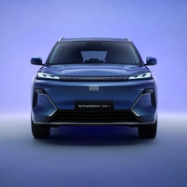 Front view of a blue StarRAY EM-1 car with illuminated headlights.