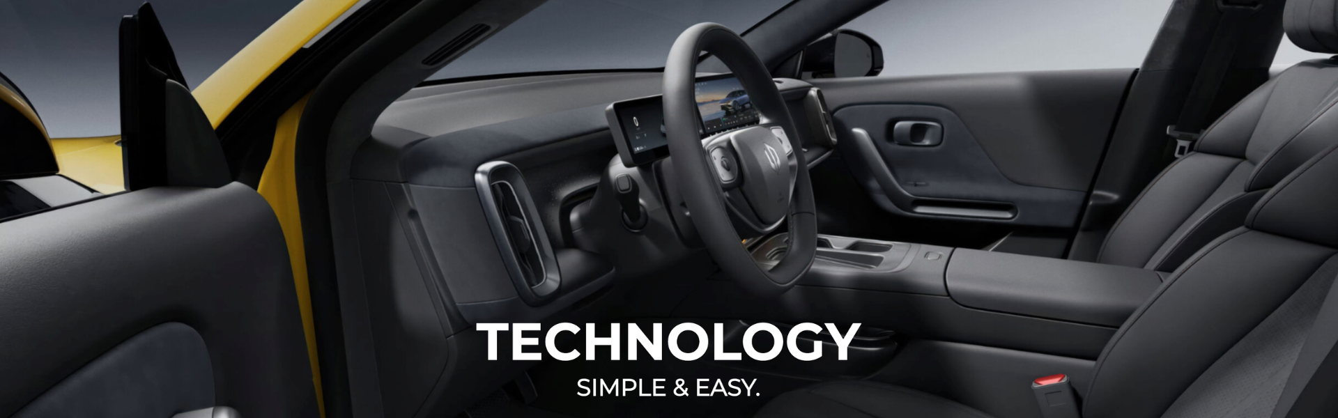 Interior view of a car showing the dashboard and steering wheel from the driver's side.