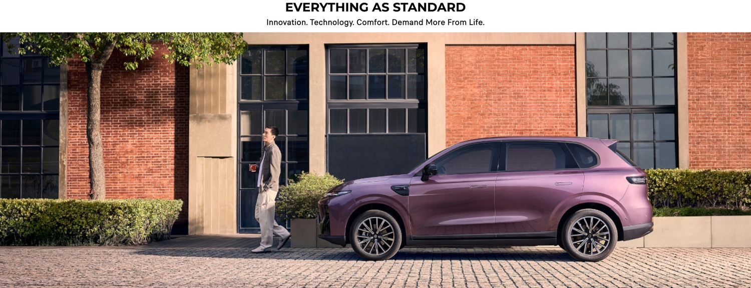 A person with a coffee walking past a parked purple SUV.