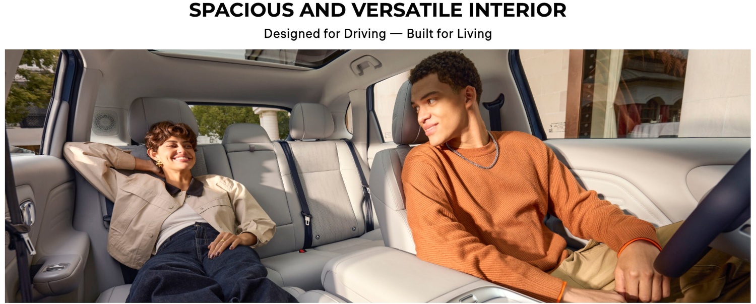 Two people sitting inside a car, showcasing its spacious interior.