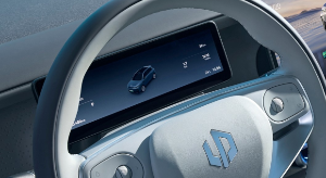 Car steering wheel with digital dashboard display showing vehicle information.