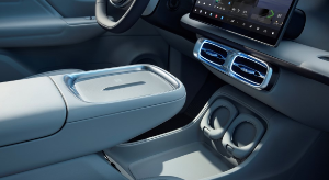 Car interior featuring a touchscreen display, centre console, and cup holders.