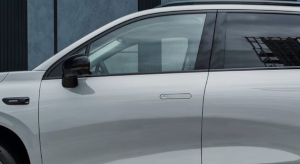 Side view of a silver car showing the driver's side door and mirror.