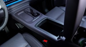 Car interior showing the centre console and storage compartment in close-up view.