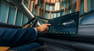 Person interacting with car's touchscreen display showing vehicle information and controls.