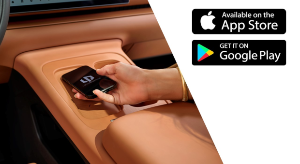 Hand placing a phone in a car console next to App Store and Google Play logos.