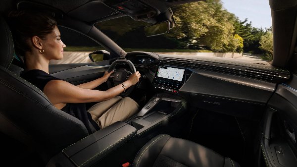 Woman driving a car with a digital dashboard and navigation screen.