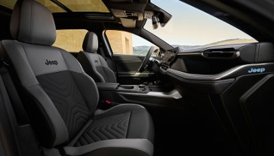 Interior view of a Jeep vehicle showing front seats and dashboard.