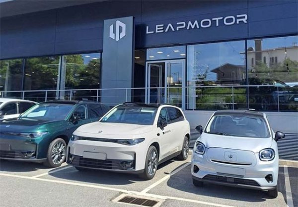 Electric vehicles parked in front of a Leapmotor showroom.