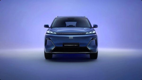 Front view of a blue Starry EM-1 SUV with illuminated headlights.
