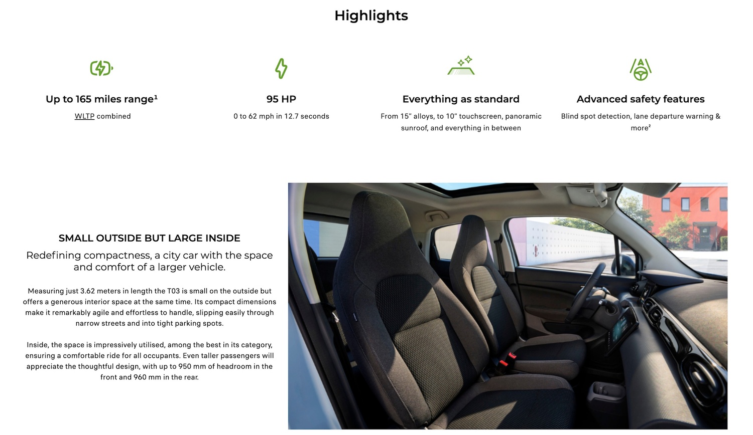 Car interior with two grey front seats and a touchscreen on the dashboard.