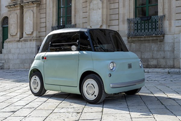 Compact mint green car with black windows and urban setting.